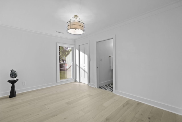 unfurnished dining area featuring light wood-type flooring, ornamental molding, and baseboards
