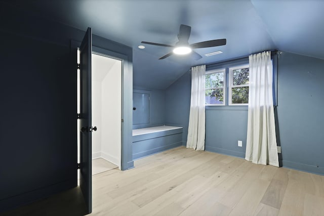 additional living space with baseboards, ceiling fan, vaulted ceiling, and wood finished floors