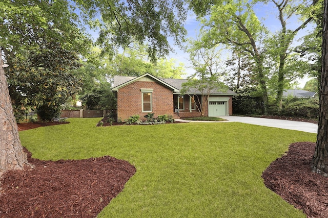 single story home featuring a front lawn, fence, brick siding, concrete driveway, and an attached garage