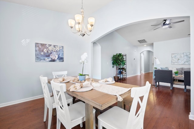 dining area with arched walkways, visible vents, baseboards, and wood finished floors