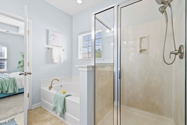 bathroom featuring a bath, tile patterned flooring, a shower stall, and ensuite bath