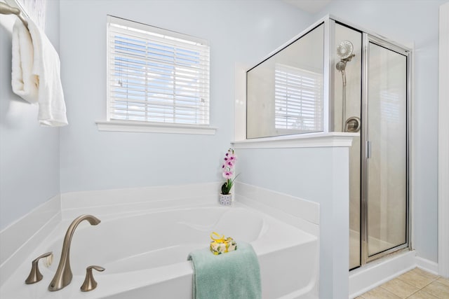 full bathroom with tile patterned floors, a stall shower, and a bath