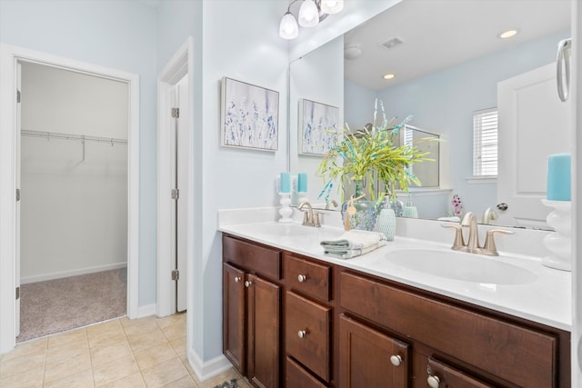 full bath featuring tile patterned flooring, double vanity, visible vents, and a sink