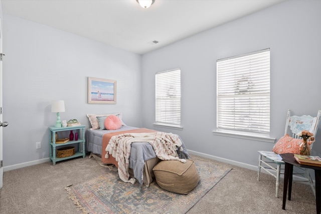 bedroom featuring visible vents, baseboards, and carpet