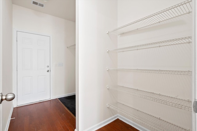 interior space with dark wood finished floors and visible vents