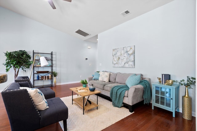 living room with ceiling fan, wood finished floors, visible vents, and baseboards