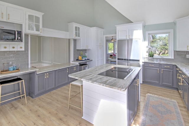 kitchen featuring backsplash, gray cabinets, and white cabinetry