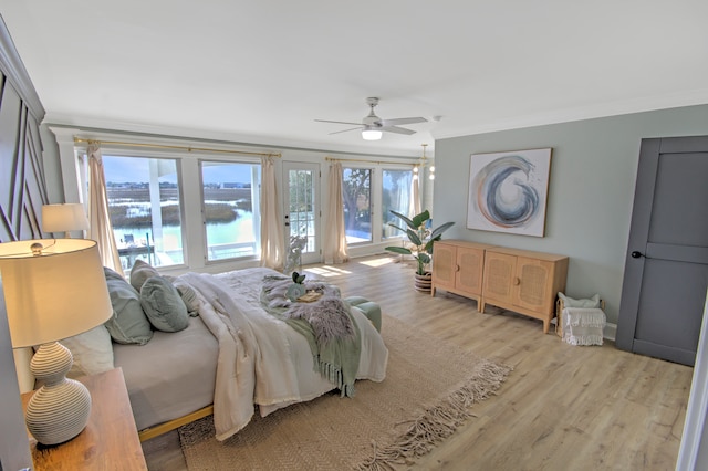 bedroom featuring ceiling fan, crown molding, and light hardwood / wood-style flooring