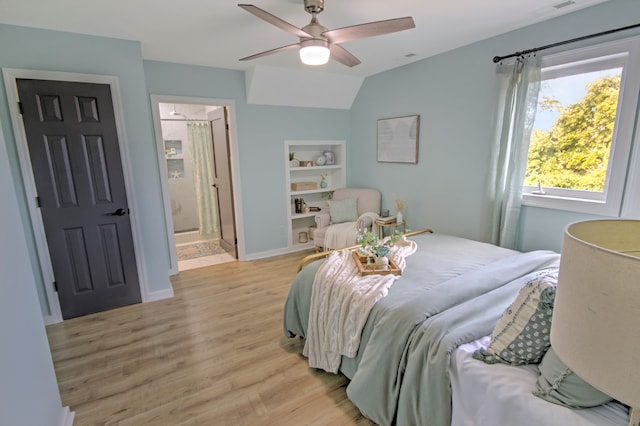 bedroom with connected bathroom, ceiling fan, lofted ceiling, and light hardwood / wood-style flooring