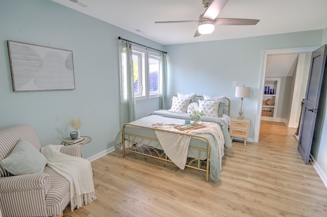 bedroom with ceiling fan and light hardwood / wood-style flooring