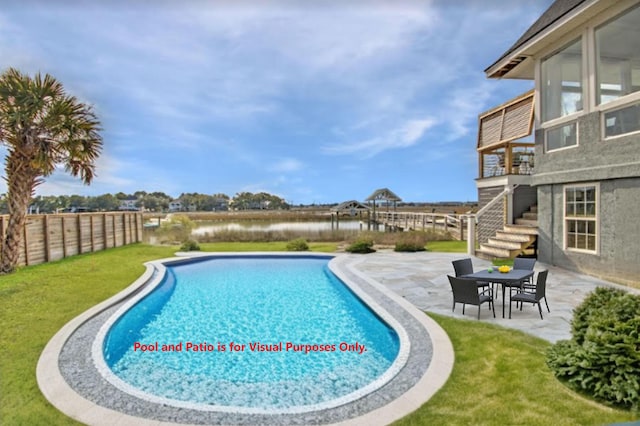 view of swimming pool with a yard and a patio area