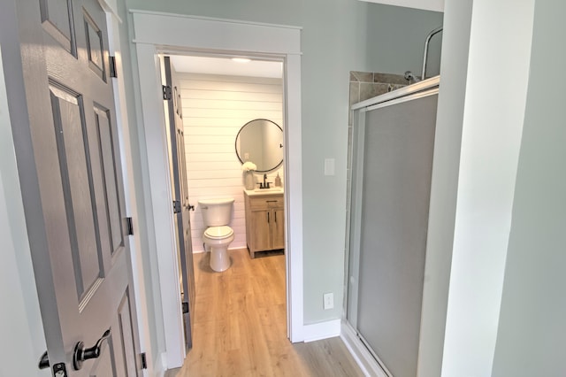 bathroom with vanity, wood-type flooring, toilet, and walk in shower