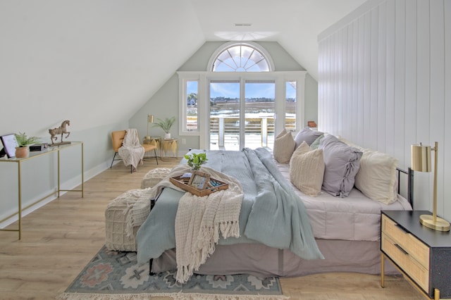 bedroom featuring vaulted ceiling and light wood-type flooring