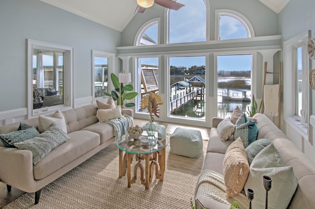 sunroom / solarium with a healthy amount of sunlight, vaulted ceiling, and ceiling fan