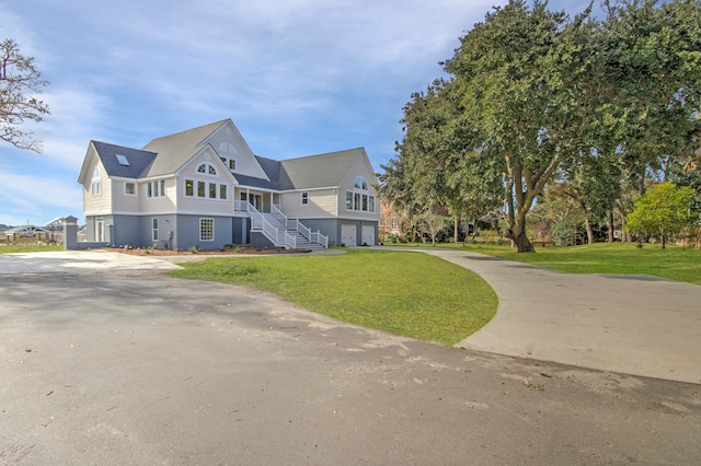 view of front of home with a front yard and a garage