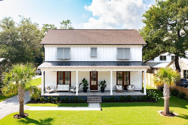 modern farmhouse featuring a porch and a front lawn