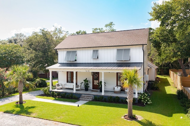 modern farmhouse style home with a porch and a front yard