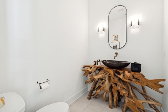 bathroom featuring sink, tile patterned floors, and toilet