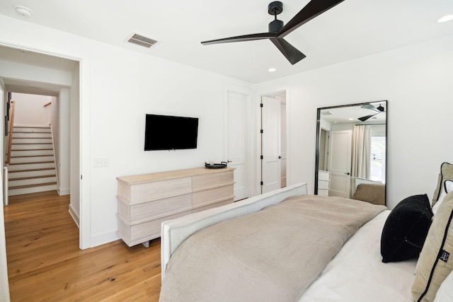 bedroom with ceiling fan and light wood-type flooring