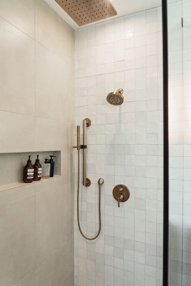 bathroom with tiled shower