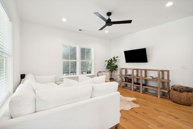 living room featuring hardwood / wood-style floors and ceiling fan