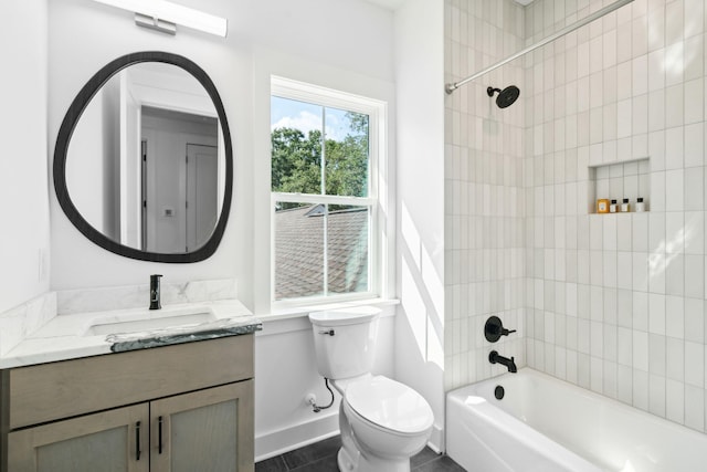 full bathroom featuring vanity, toilet, and tiled shower / bath