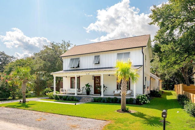 modern farmhouse featuring a porch and a front lawn