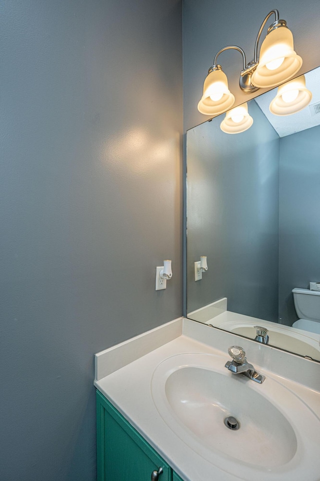 bathroom featuring vanity and toilet