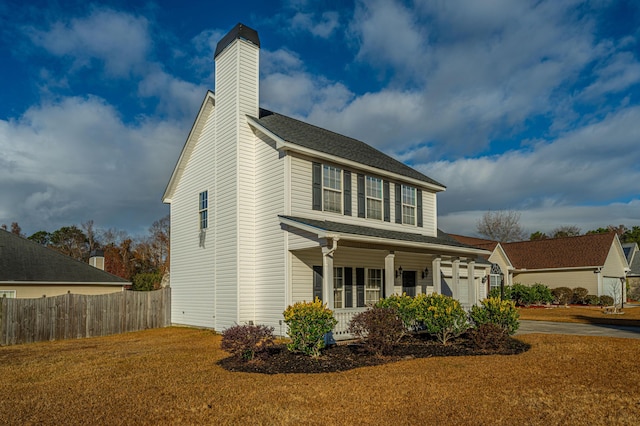 view of front facade with a garage, a front lawn, and a porch