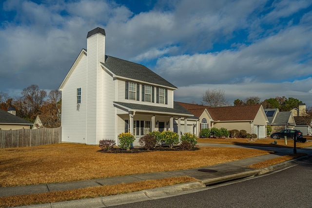 view of front facade with a garage, a front yard, and a porch