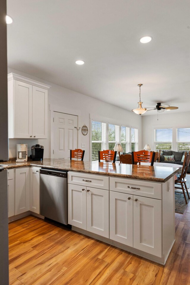 31 W 9th St, Folly Beach, SC 29439 - kitchen featuring stainless steel dishwasher, white cabinetry, light wood-style floors, a peninsula, and a ceiling fan
