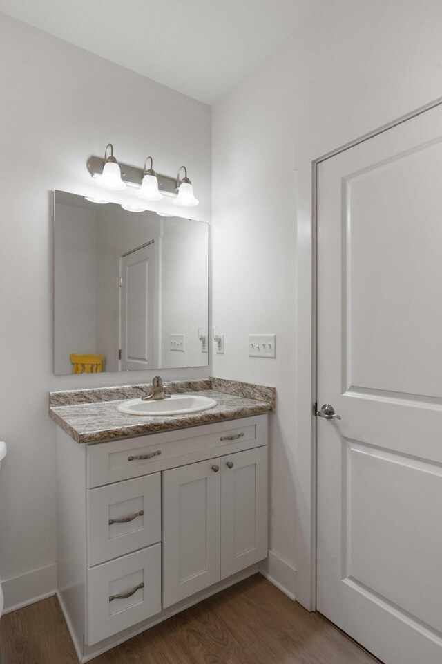 31 W 9th St, Folly Beach, SC 29439 - half bathroom featuring wood finished floors and vanity