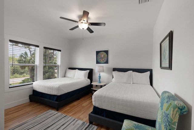 31 W 9th St, Folly Beach, SC 29439 - bedroom featuring multiple windows, wood finished floors, and a ceiling fan