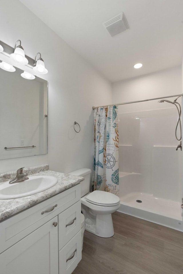 31 W 9th St, Folly Beach, SC 29439 - bathroom with vanity, curtained shower, and wood finished floors