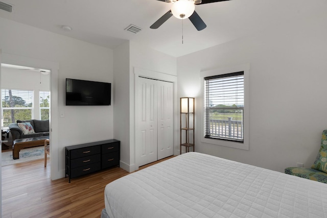 31 W 9th St, Folly Beach, SC 29439 - bedroom with multiple windows, wood finished floors, a closet, and a ceiling fan