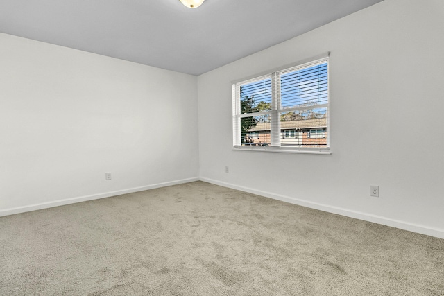 carpeted empty room with baseboards