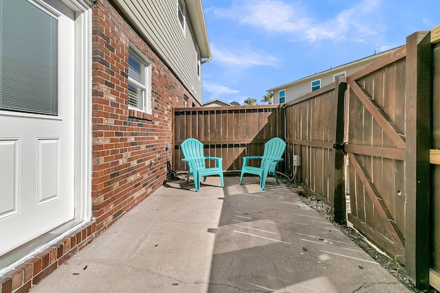 view of patio with a fenced backyard and a gate