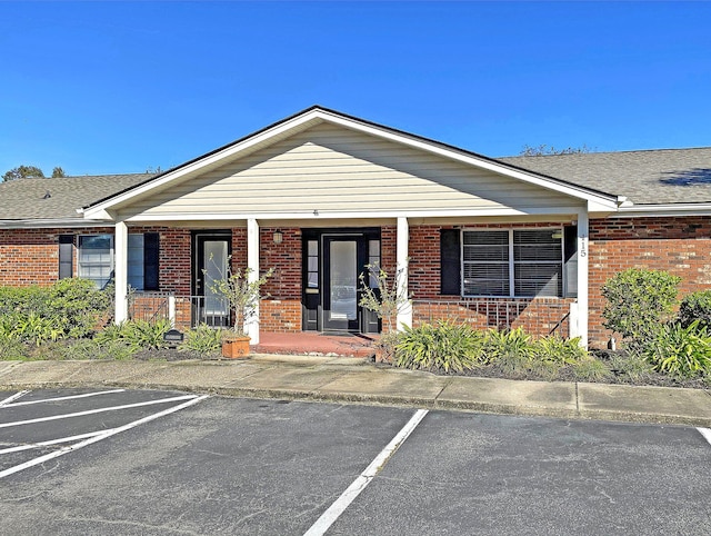 view of building exterior with uncovered parking