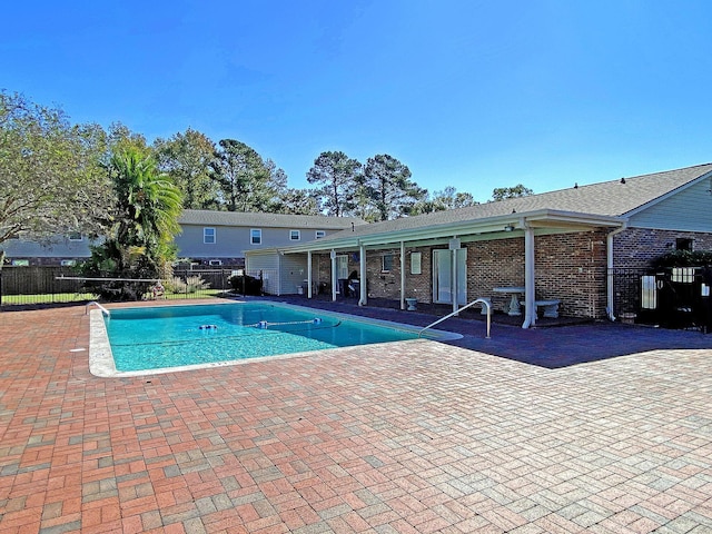 view of swimming pool with a patio, fence, and a fenced in pool