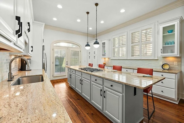 kitchen featuring sink, gray cabinets, hanging light fixtures, white cabinets, and a kitchen island