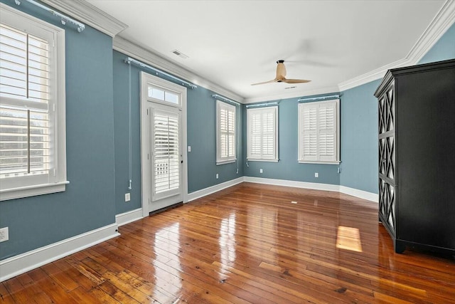 spare room featuring crown molding, ceiling fan, and dark hardwood / wood-style flooring