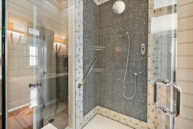 bathroom featuring a shower with shower door and hardwood / wood-style floors