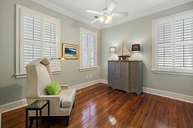 living area with dark wood-type flooring, ceiling fan, and ornamental molding