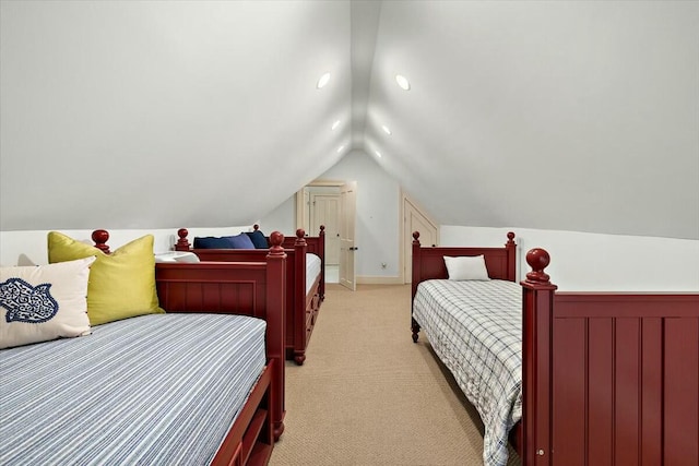 bedroom featuring vaulted ceiling and light carpet