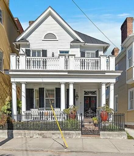 view of front facade featuring a balcony and a porch