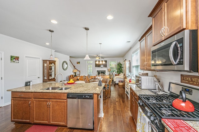 5442 Clearview Dr, North Charleston, SC 29420 - kitchen featuring stainless steel appliances, a sink, a kitchen island with sink, dark wood finished floors, and brown cabinets