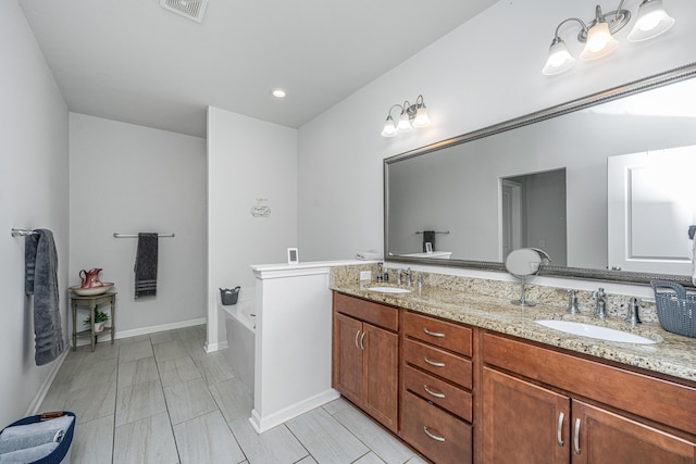 5442 Clearview Dr, North Charleston, SC 29420 - bathroom featuring double vanity, a bath, and baseboards