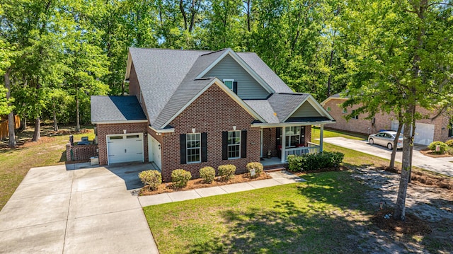 5442 Clearview Dr, North Charleston, SC 29420 - traditional home featuring covered porch, a garage, concrete driveway, a front lawn, and roof with shingles