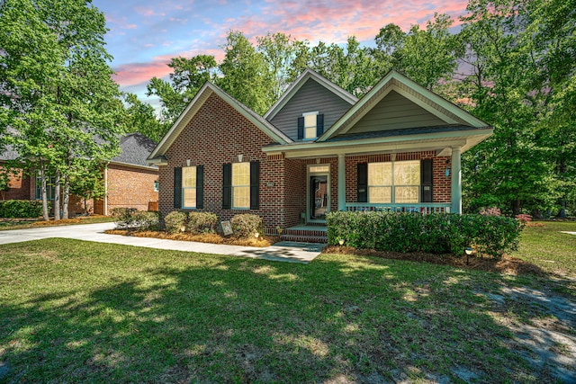 5442 Clearview Dr, North Charleston, SC 29420 - traditional home featuring covered porch, brick siding, and a front lawn