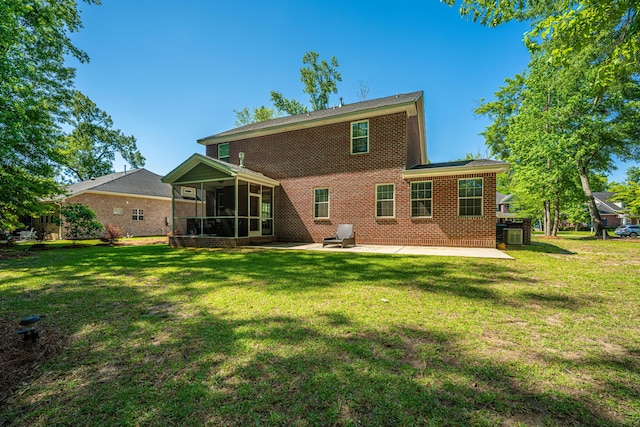 5442 Clearview Dr, North Charleston, SC 29420 - rear view of house featuring a patio, a sunroom, a yard, and brick siding